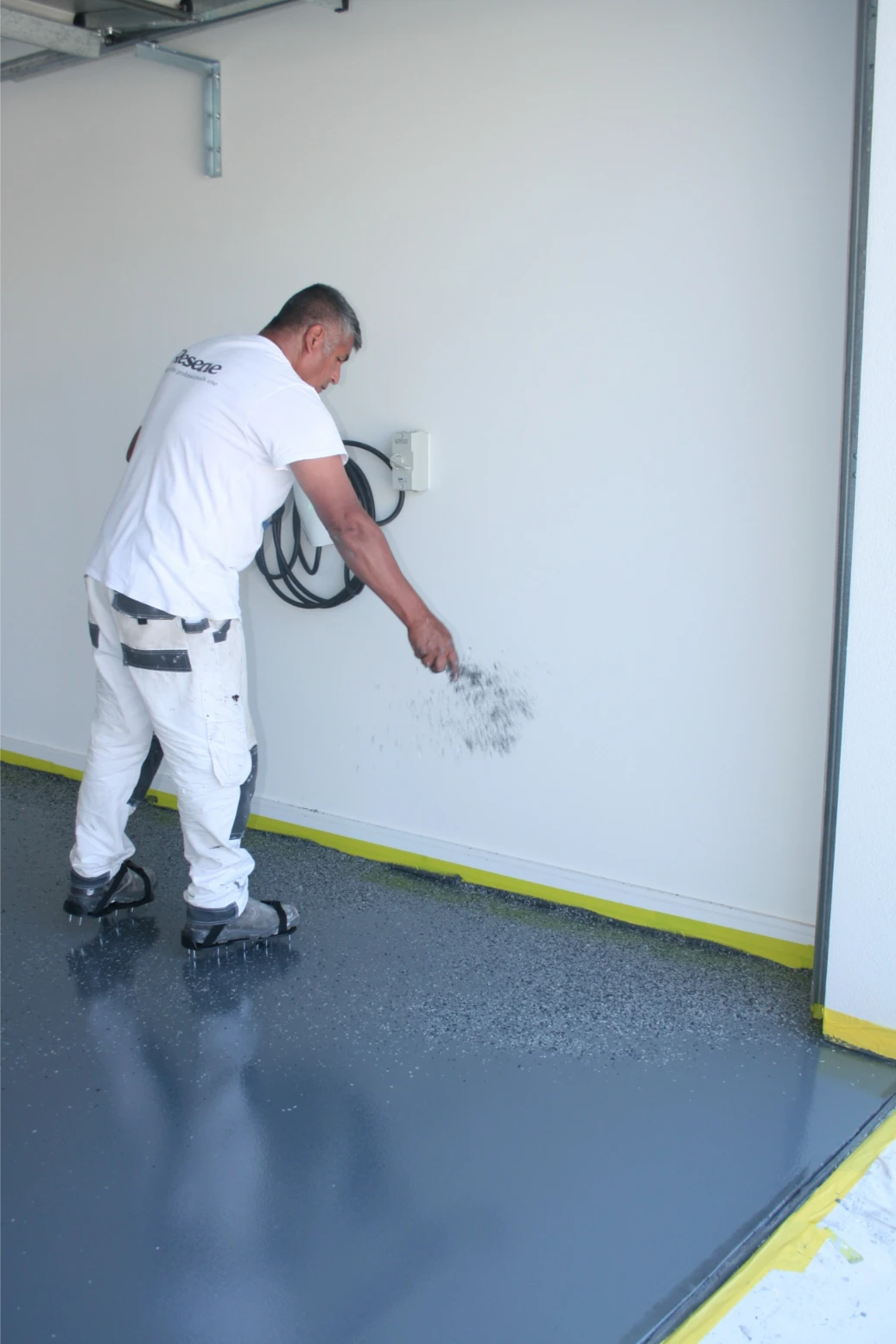 Painter removing graffiti from wall