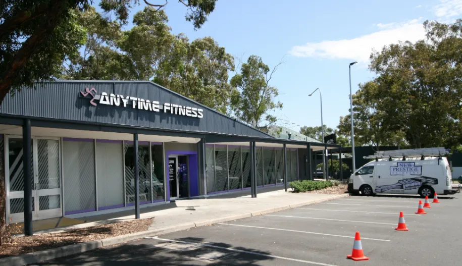 Anytime Fitness gym exterior with parked van