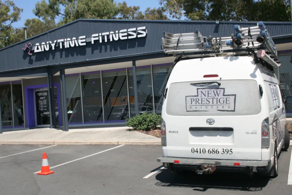 Anytime Fitness gym behind parked painter's van