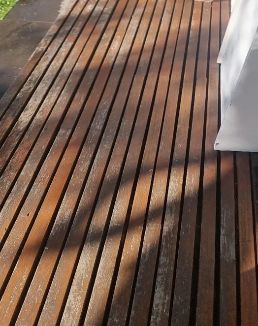 Sunlight casting stripes on a wooden deck.