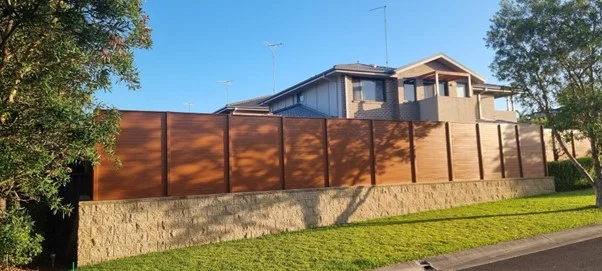 Suburban house with tall wooden fence