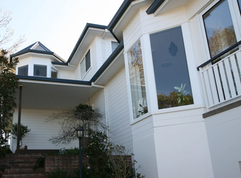 Elegant white house with large windows and balcony
