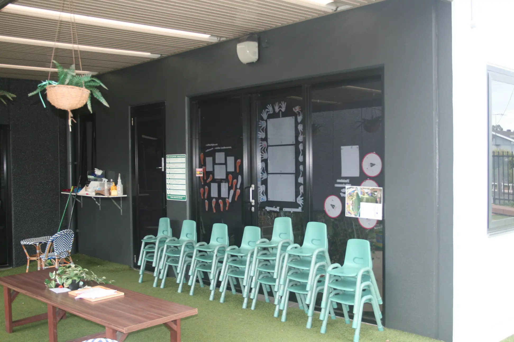 Outdoor seating area with teal chairs at modern cafe