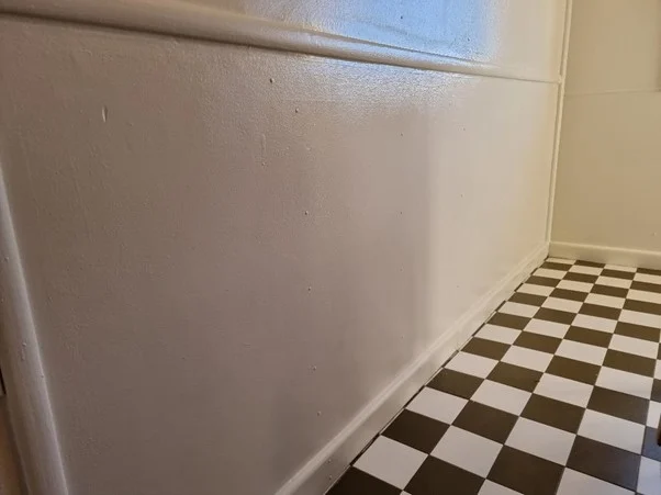 White wall above black and white checkered floor