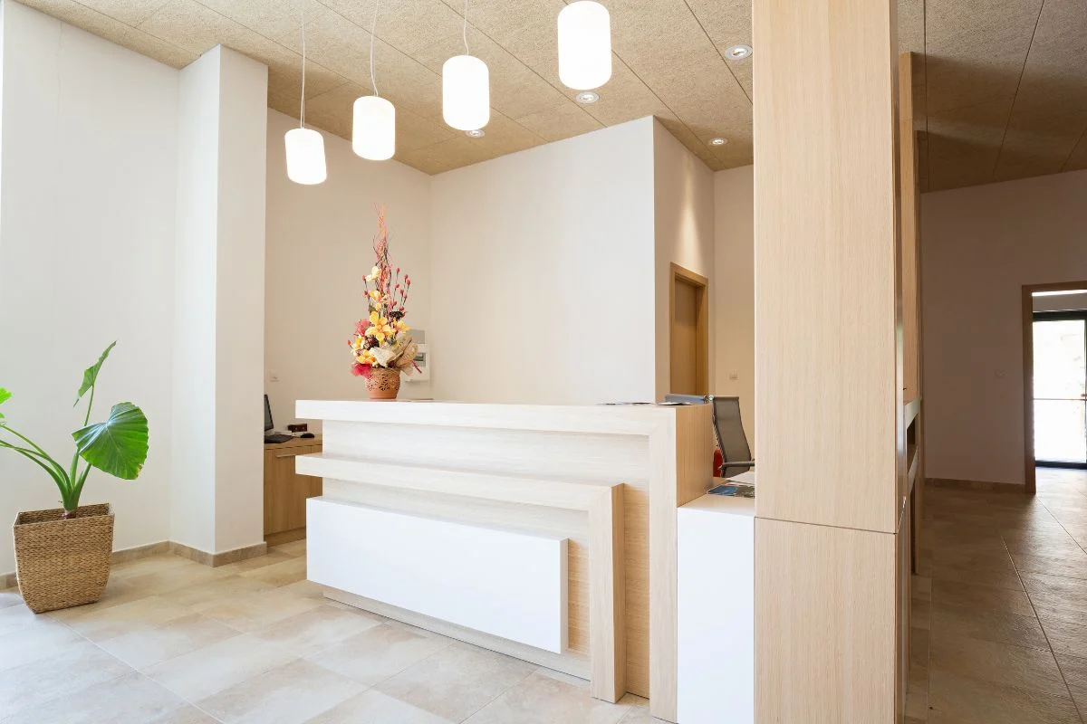 Modern office lobby with reception desk and floral decoration