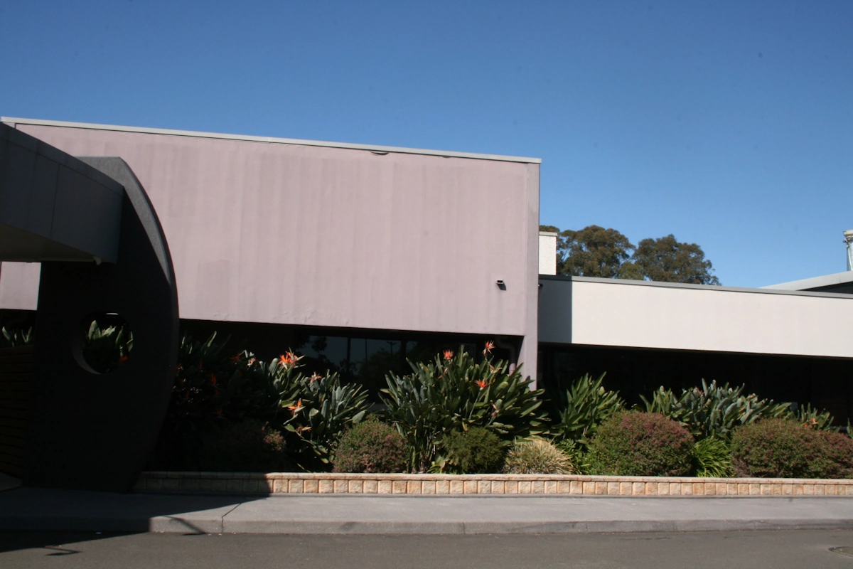 Modern building with circular architectural elements and landscaping