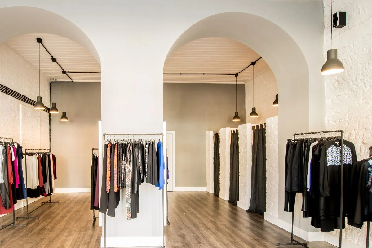 Modern clothing store interior with arched doorways.