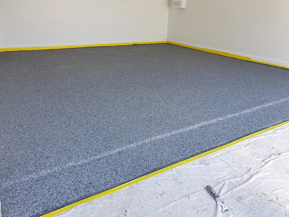 Fresh grey carpet installation in room with yellow trim
