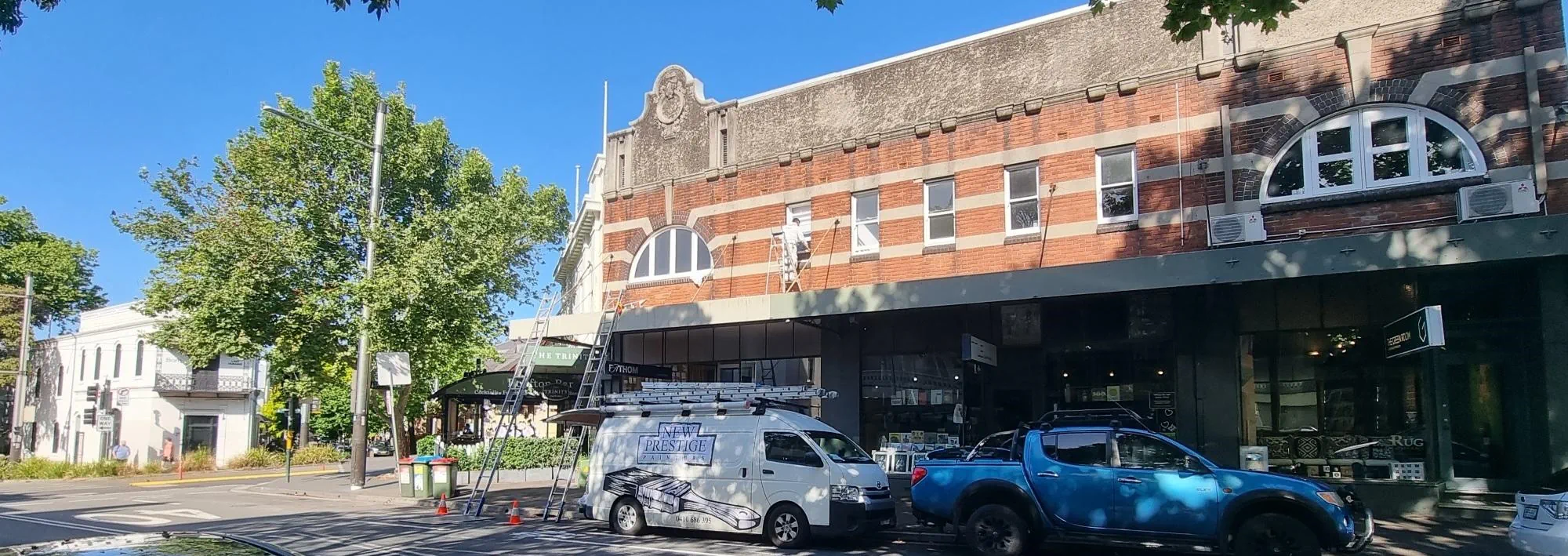 Sunny street view with historic buildings and parked cars